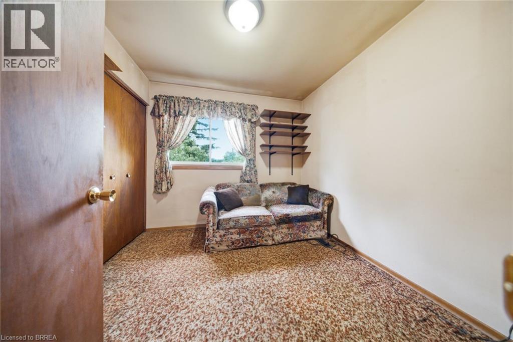 Room featuring wall-to-wall carpeting, wood-paneled closet doors, and a window providing natural light - 1598 Highway No 6, Hamilton, ON - Indoor Photo Showing Other Room