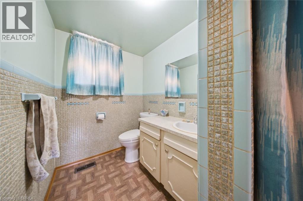 Bathroom featuring a single vanity, integrated sink, and undermount cabinetry - 1598 Highway No 6, Hamilton, ON - Indoor Photo Showing Bathroom