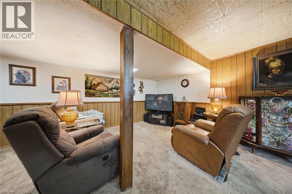 Finished room featuring wood-paneling accents and textured ceiling - 1598 Highway No 6, Hamilton, ON - Indoor