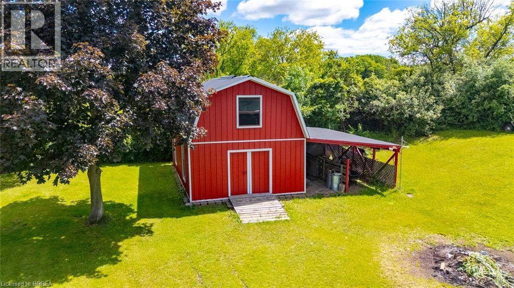 Red barn structure featuring a gambrel roof and white trim accents - 1598 Highway No 6, Hamilton, ON - Outdoor