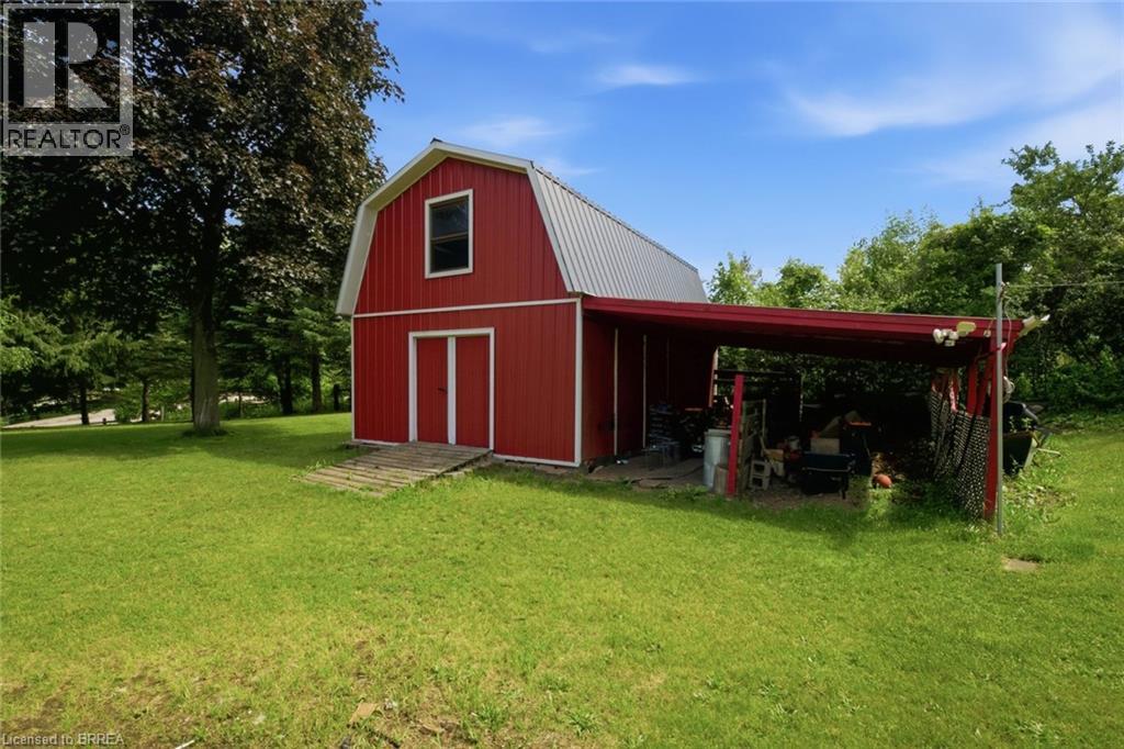 Red barn structure with a gambrel roof and an attached side carport - 1598 Highway No 6, Hamilton, ON - Outdoor
