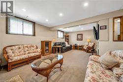 Spacious lower-level living area featuring recessed lighting, neutral wall tones, and carpet flooring - 