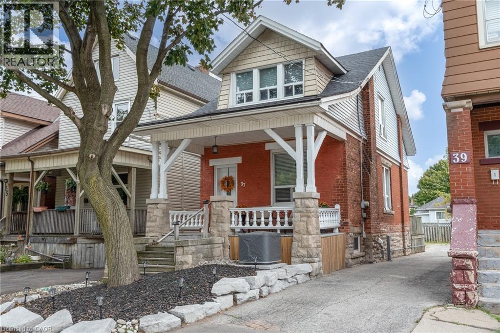 Brick and siding exterior with a covered front porch featuring stone balusters and columns - 37 Cliff Avenue Unit# Upper, Hamilton, ON - Outdoor With Facade