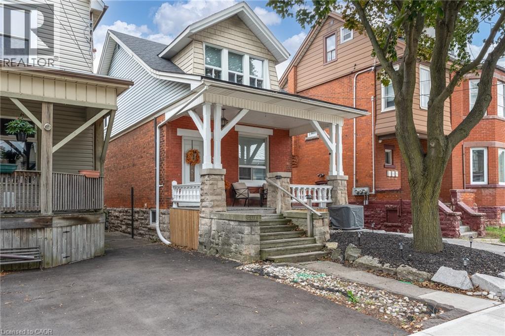Brick facade residence with a covered front porch featuring stone pillars and balusters - 37 Cliff Avenue Unit# Upper, Hamilton, ON - Outdoor