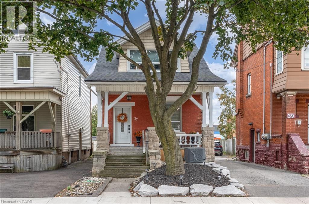 Red brick facade with stone accents and a covered front porch - 37 Cliff Avenue Unit# Upper, Hamilton, ON - Outdoor With Facade