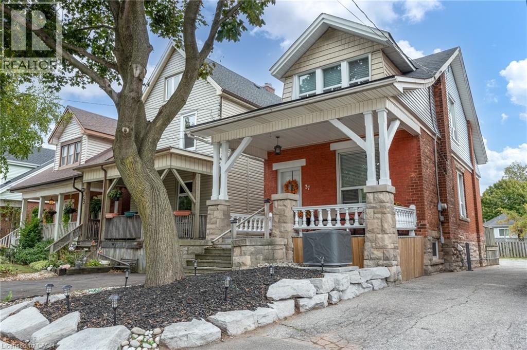 Brick exterior featuring a stone foundation and covered front porch - 37 Cliff Avenue Unit# Upper, Hamilton, ON - Outdoor With Facade