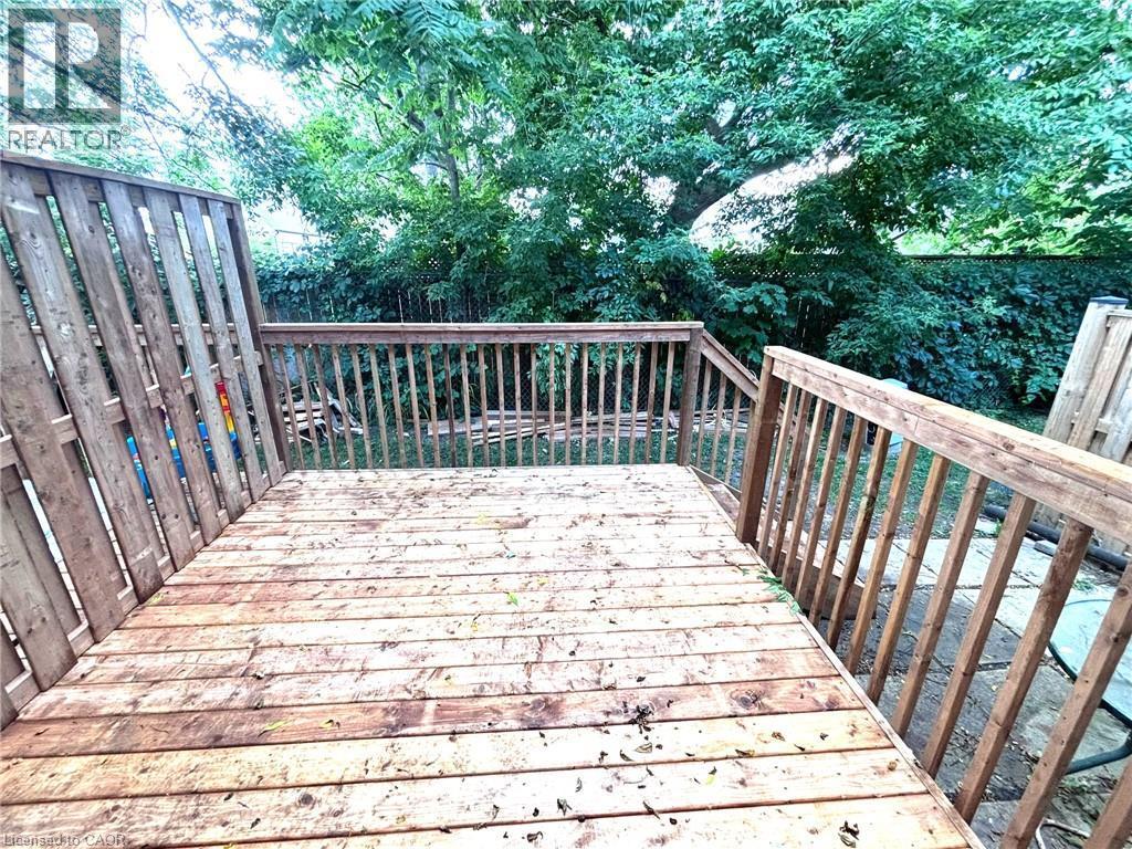 Spacious wood deck featuring a natural wood finish, complete with matching wood railings and privacy fencing - 490 Third Street Unit# 40, London, ON - Outdoor With Deck Patio Veranda