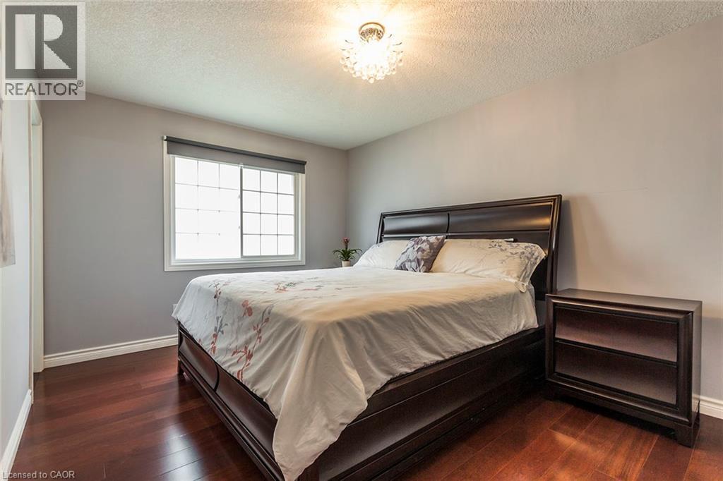 Hardwood flooring complements light gray walls - 44 Lemon Grass Street, Kitchener, ON - Indoor Photo Showing Bedroom