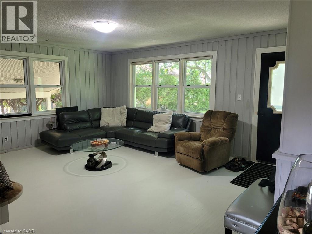 Living space featuring light-colored flooring and paneling - 879 West 5Th Street, Hamilton, ON - Indoor Photo Showing Living Room
