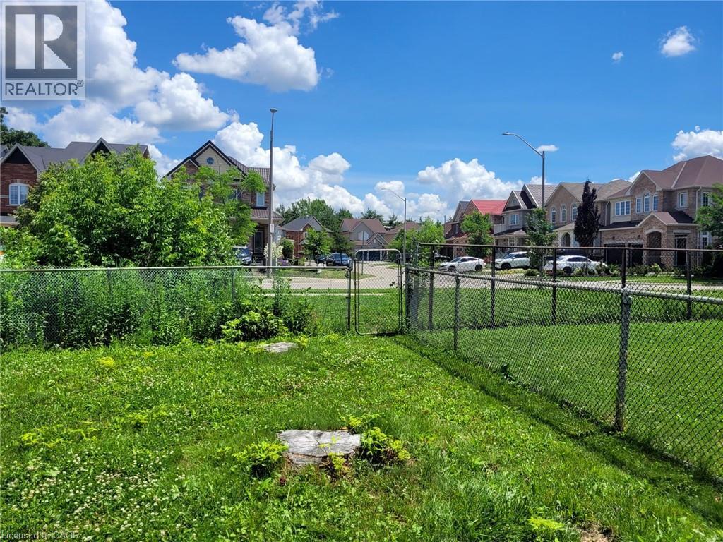 Expansive green space featuring a chain-link fence - 879 West 5Th Street, Hamilton, ON - Outdoor