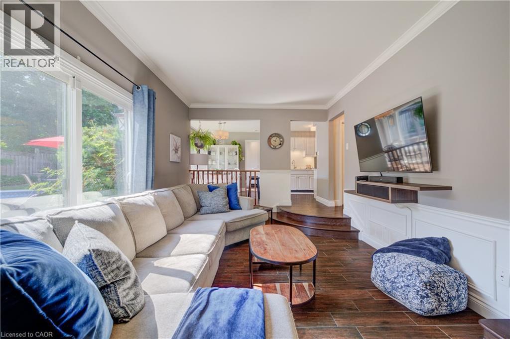 Living area featuring dark wood-finish flooring, light grey walls, and white crown molding - 41 Mcniven Road, Ancaster, ON - Indoor Photo Showing Living Room