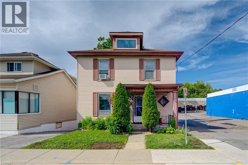 Two-story home with light-colored siding, a dormer window, and a covered front porch - 39 Kerr Street, Cambridge, ON - Outdoor With Facade