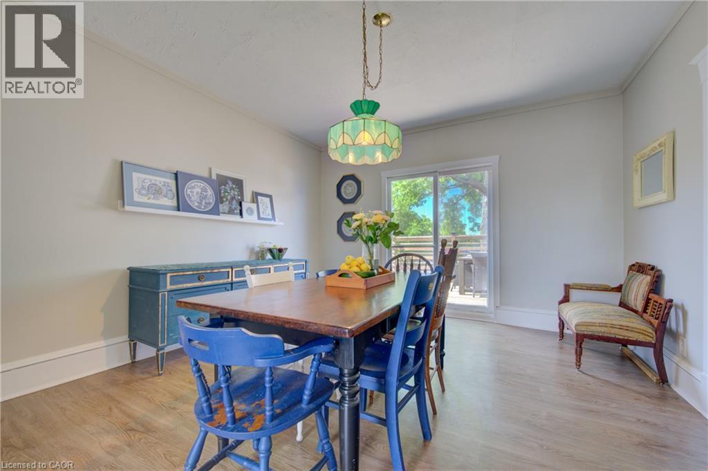 Spacious dining area featuring wood-finish flooring, a sliding glass door for outdoor access, and ample natural light - 39 Kerr Street, Cambridge, ON - Indoor Photo Showing Dining Room