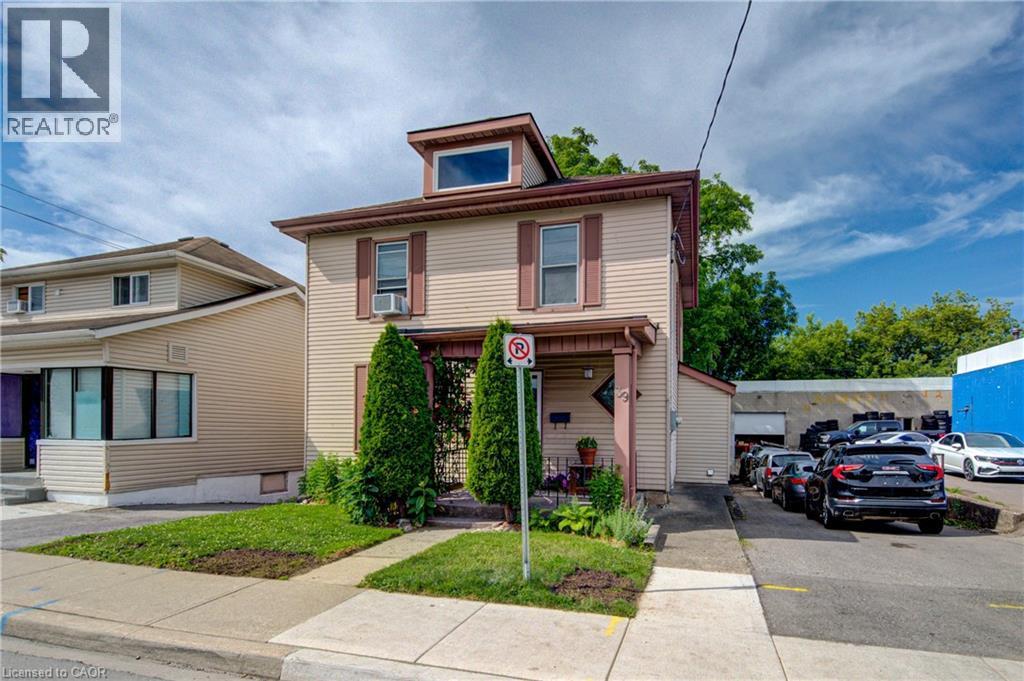 Two-story residence featuring light-toned horizontal siding and a dormer window - 39 Kerr Street, Cambridge, ON - Outdoor