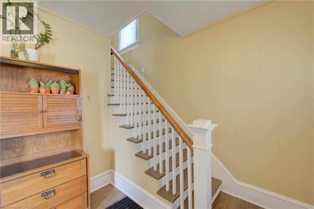 Staircase featuring wood-finish treads, white risers, a wood handrail, and white balusters - 39 Kerr Street, Cambridge, ON - Indoor Photo Showing Other Room
