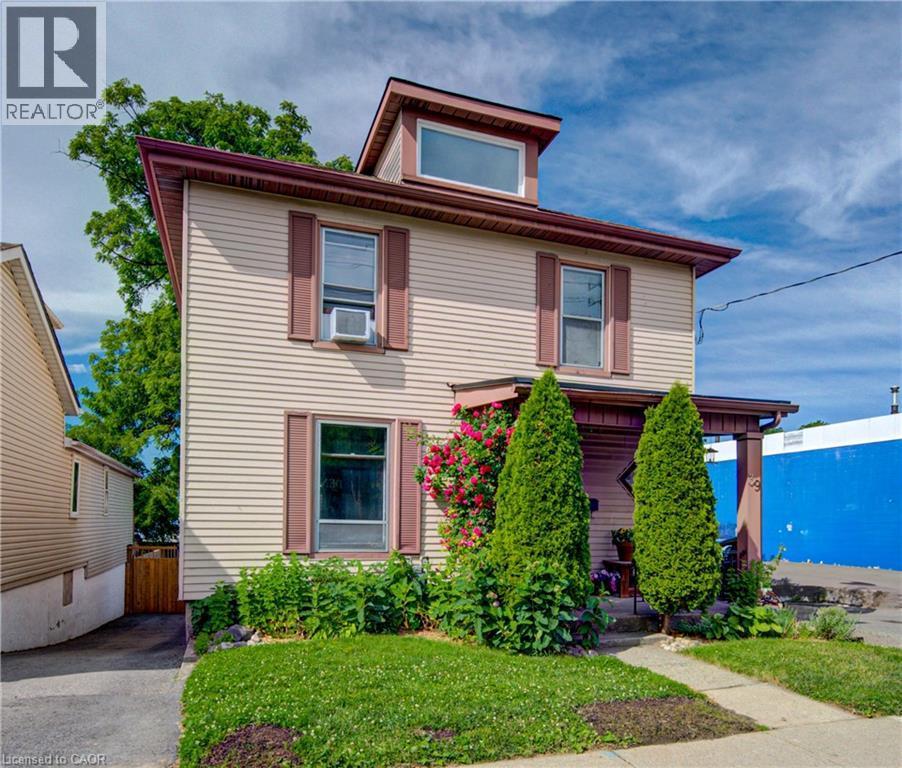 Two-story residence featuring light-colored horizontal siding and a dormer window - 39 Kerr Street, Cambridge, ON - Outdoor