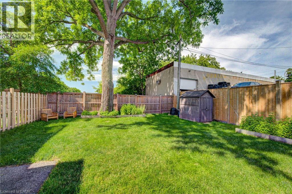 Expansive backyard featuring a large tree, a storage shed, and a privacy fence - 39 Kerr Street, Cambridge, ON - Outdoor