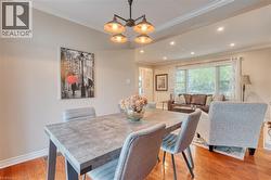 Dining area featuring a modern four-light chandelier, recessed lighting, and crown molding -