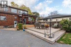 Multi-level wooden deck featuring a covered pergola and integrated steps -