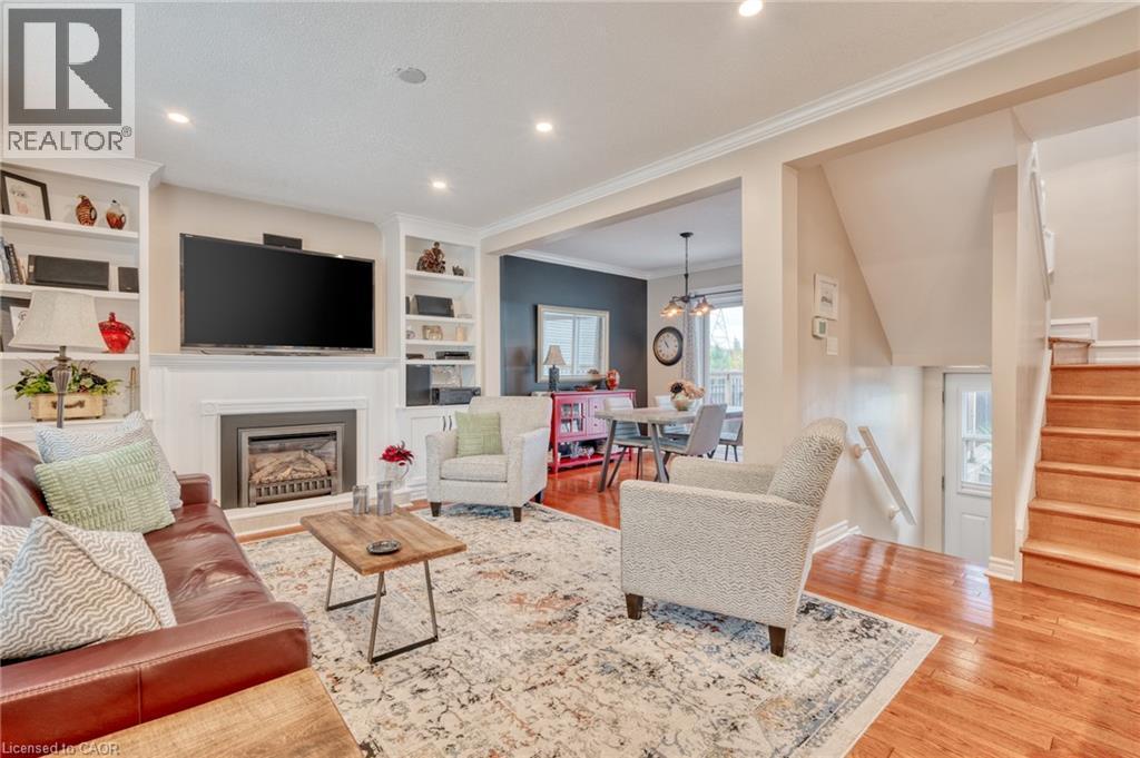 Living area featuring a built-in fireplace, recessed lighting, hardwood flooring, built-in shelving, and crown molding - 851 Beach Boulevard, Hamilton, ON - Indoor Photo Showing Living Room With Fireplace