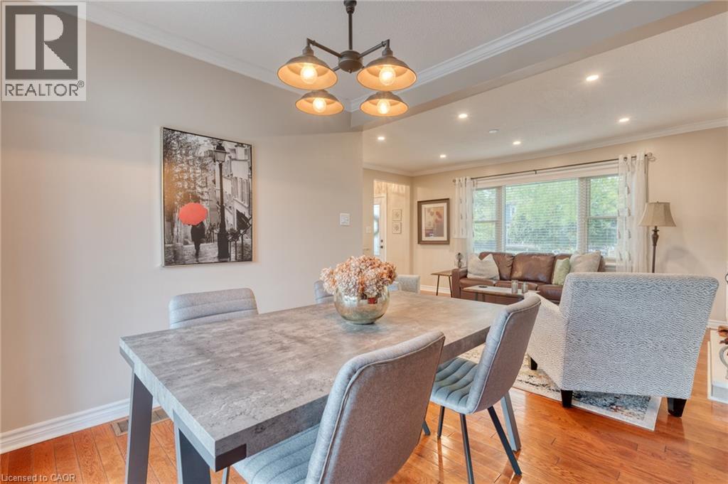 Dining area featuring a modern four-light chandelier, recessed lighting, and crown molding - 851 Beach Boulevard, Hamilton, ON - Indoor Photo Showing Dining Room