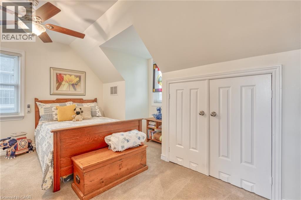 Carpeted room with a ceiling fan, sloped ceilings, and a window with blinds - 851 Beach Boulevard, Hamilton, ON - Indoor Photo Showing Bedroom