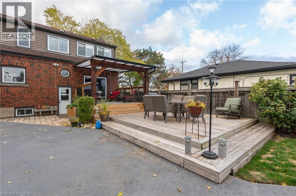 Multi-level wooden deck featuring a covered pergola and integrated steps - 851 Beach Boulevard, Hamilton, ON - Outdoor With Deck Patio Veranda