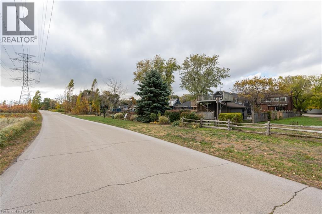 Paved road with split-rail fencing bordering the property - 851 Beach Boulevard, Hamilton, ON - Outdoor