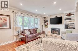 Living area featuring wood-finish flooring and crown molding -