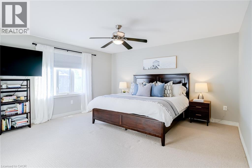 Spacious room featuring light-colored carpeting and a window with white drapery - 7 Kinsman Drive, Binbrook, ON - Indoor Photo Showing Bedroom