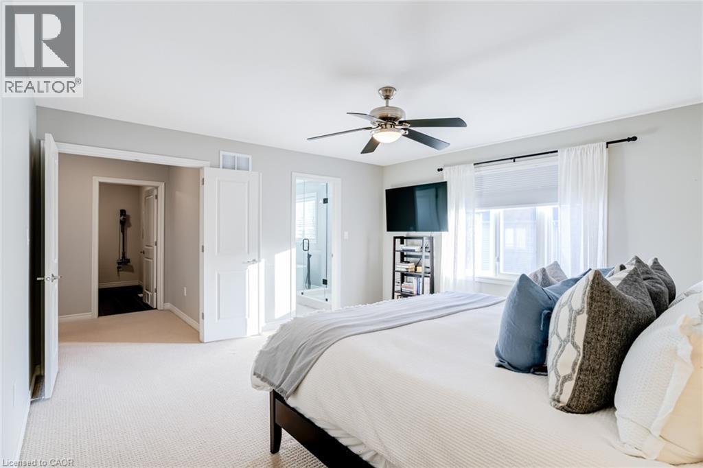 Carpeted room featuring light gray wall paint, a ceiling fan with light, and a window with white blinds and sheer curtains - 7 Kinsman Drive, Binbrook, ON - Indoor Photo Showing Bedroom