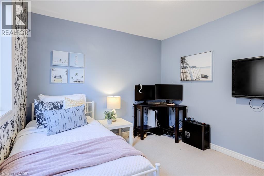 Bedroom featuring a single window, light blue walls, and a patterned accent wall - 7 Kinsman Drive, Binbrook, ON - Indoor Photo Showing Bedroom