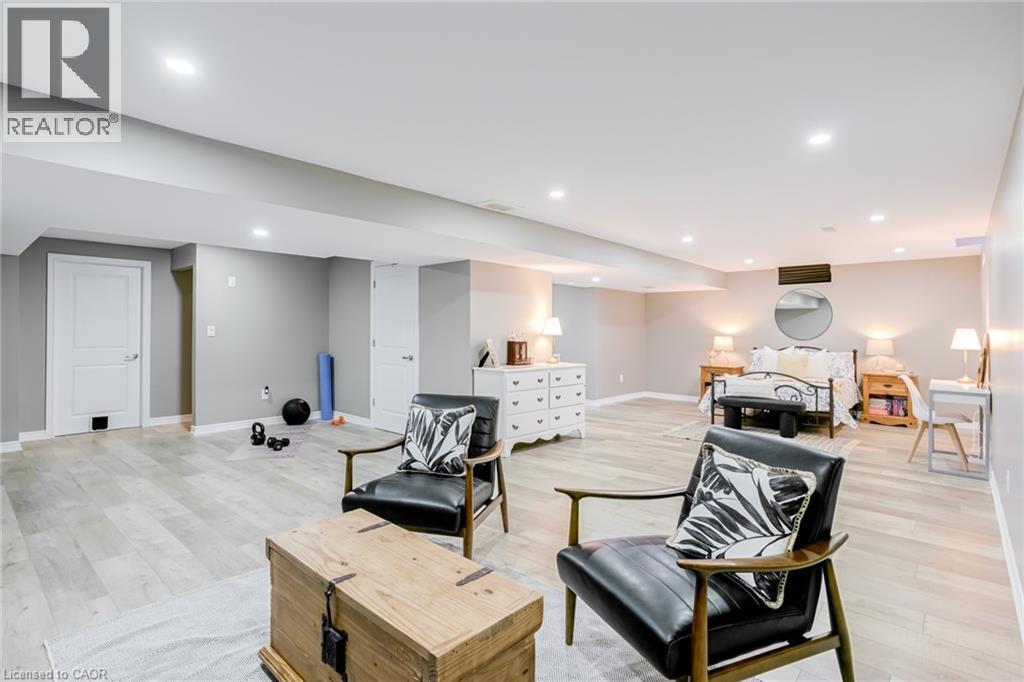 Spacious room featuring wood-finish flooring, recessed lighting, and light gray wall paint - 7 Kinsman Drive, Binbrook, ON - Indoor