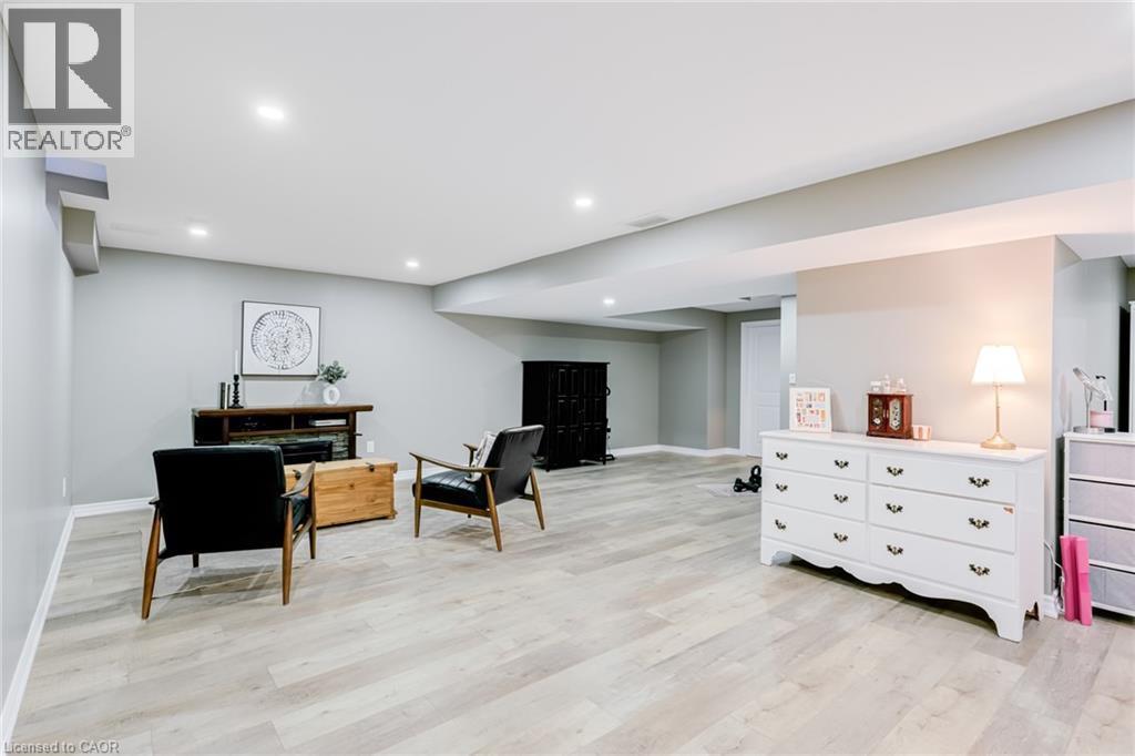 Spacious room featuring light wood-finish flooring, recessed lighting, and light grey wall tones - 7 Kinsman Drive, Binbrook, ON - Indoor