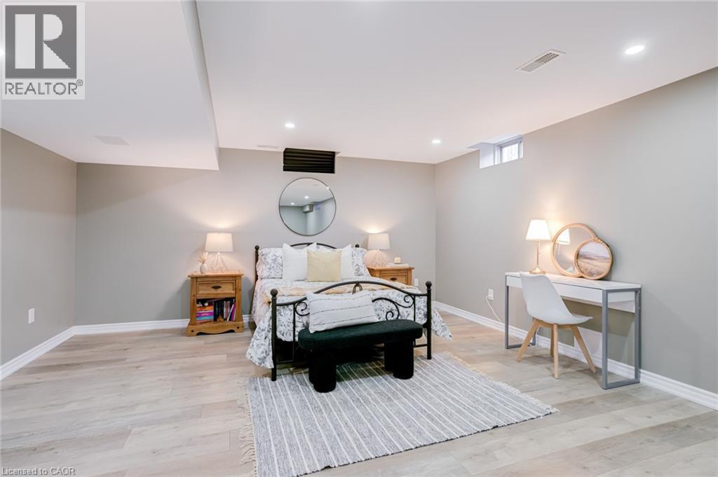 Bedroom featuring light wood-finish flooring, recessed lighting, and a neutral wall color - 7 Kinsman Drive, Binbrook, ON - Indoor Photo Showing Bedroom