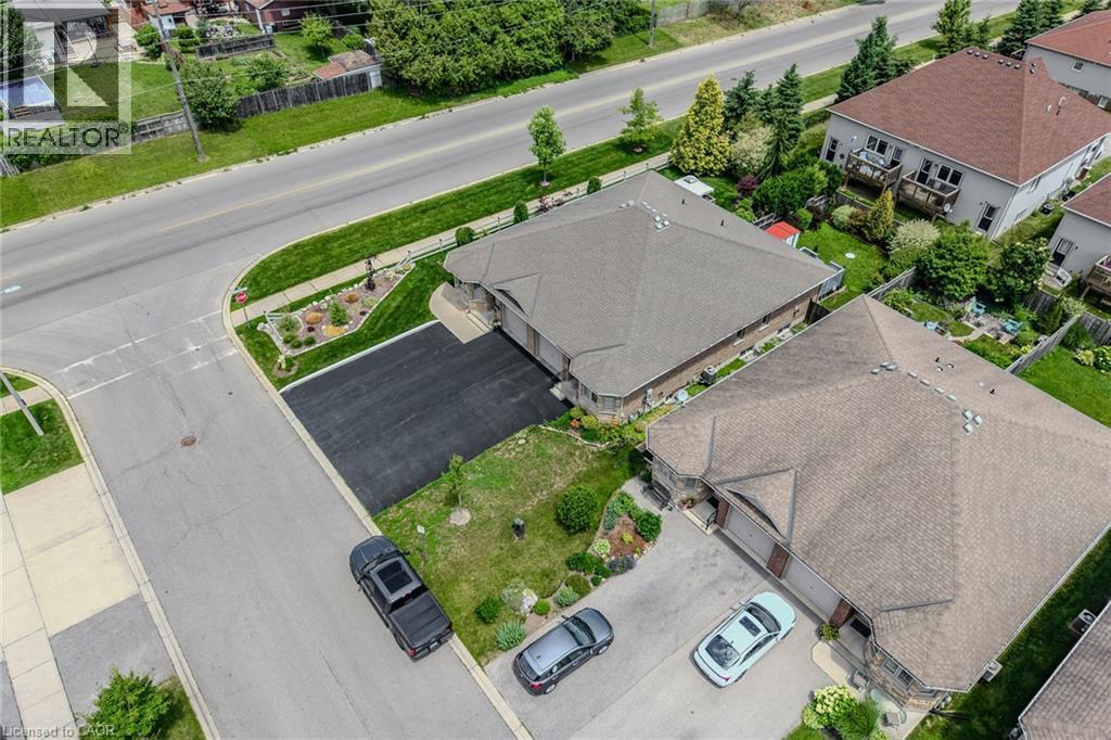 Aerial perspective highlighting a residential property with a multi-car paved driveway - 51 Millcroft Drive, Simcoe, ON - Outdoor With View