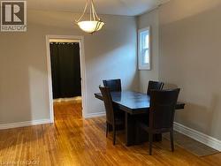 Hardwood flooring throughout, featuring a white trim package, neutral wall tones, and a single window for natural light -