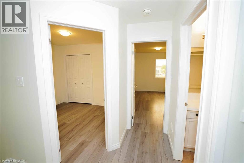 Hallway with wood-finish flooring, white walls, and recessed lighting - 18 Heritage Drive, Guelph, ON - Indoor Photo Showing Other Room