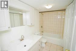 Bathroom featuring a white vanity with an integrated rectangular sink, brushed nickel faucet, and a stone-finish countertop -