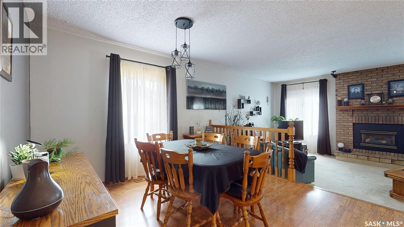 1358 Lakewood Crescent N, Regina, SK - Indoor Photo Showing Dining Room With Fireplace