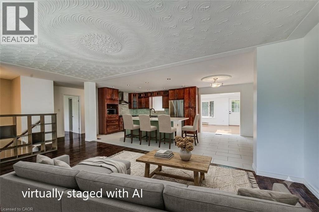Open-concept living area with dark wood-finish flooring, a textured ceiling, and recessed lighting - 109 White Oak Place, Waterloo, ON - Indoor Photo Showing Living Room