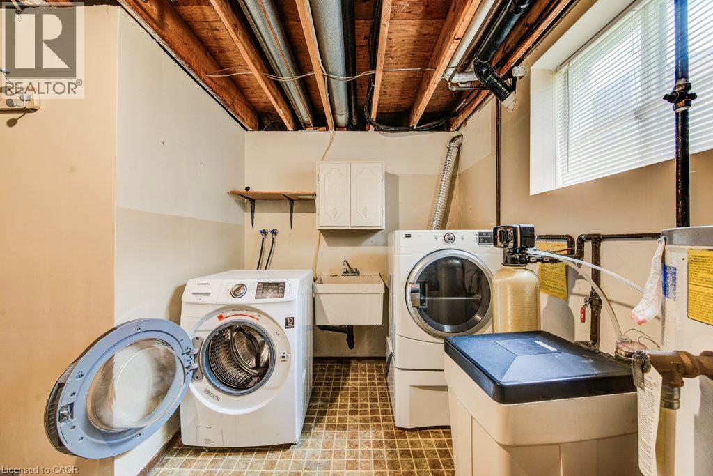 Dedicated laundry area with a utility sink and upper cabinetry - 109 White Oak Place, Waterloo, ON - Indoor Photo Showing Laundry Room