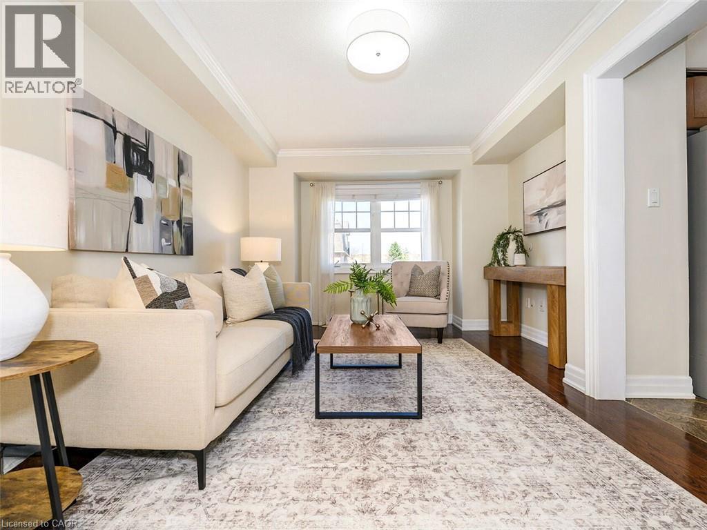 Living area featuring dark wood-finish flooring, white trim, and crown molding - 656 Frank Place, Milton, ON - Indoor Photo Showing Living Room