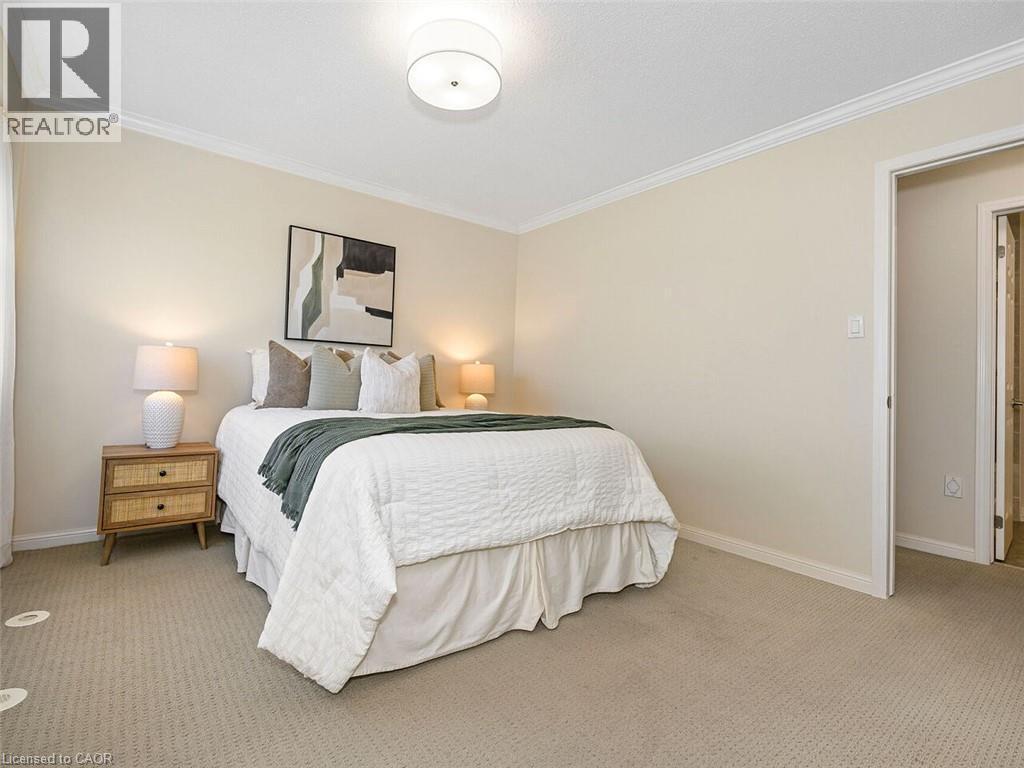 Carpeted bedroom featuring neutral wall tones and white crown molding - 656 Frank Place, Milton, ON - Indoor Photo Showing Bedroom