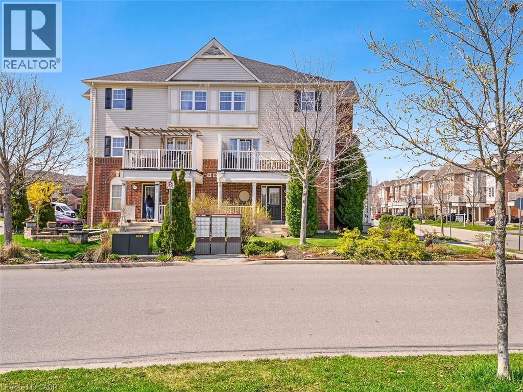 Three-story townhouse featuring a brick and siding facade with dark shutters - 656 Frank Place, Milton, ON - Outdoor With Facade