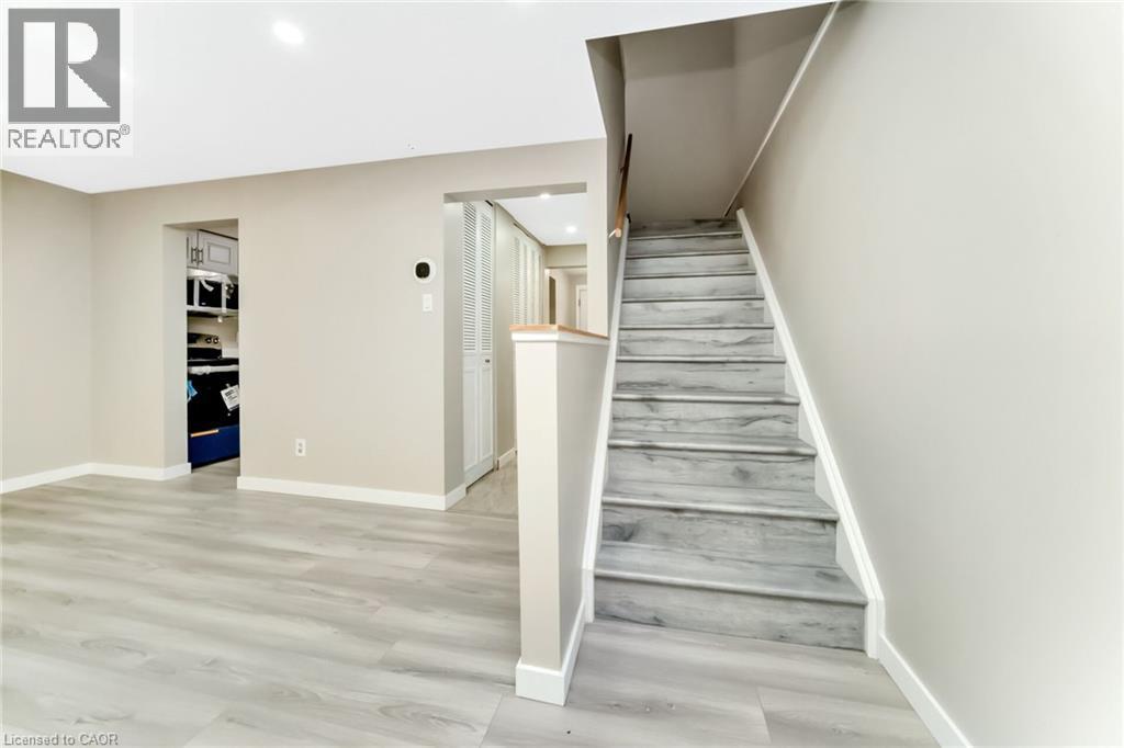 Light wood-finish flooring throughout, complemented by neutral wall tones - 53 Burns Drive, Guelph, ON - Indoor Photo Showing Other Room