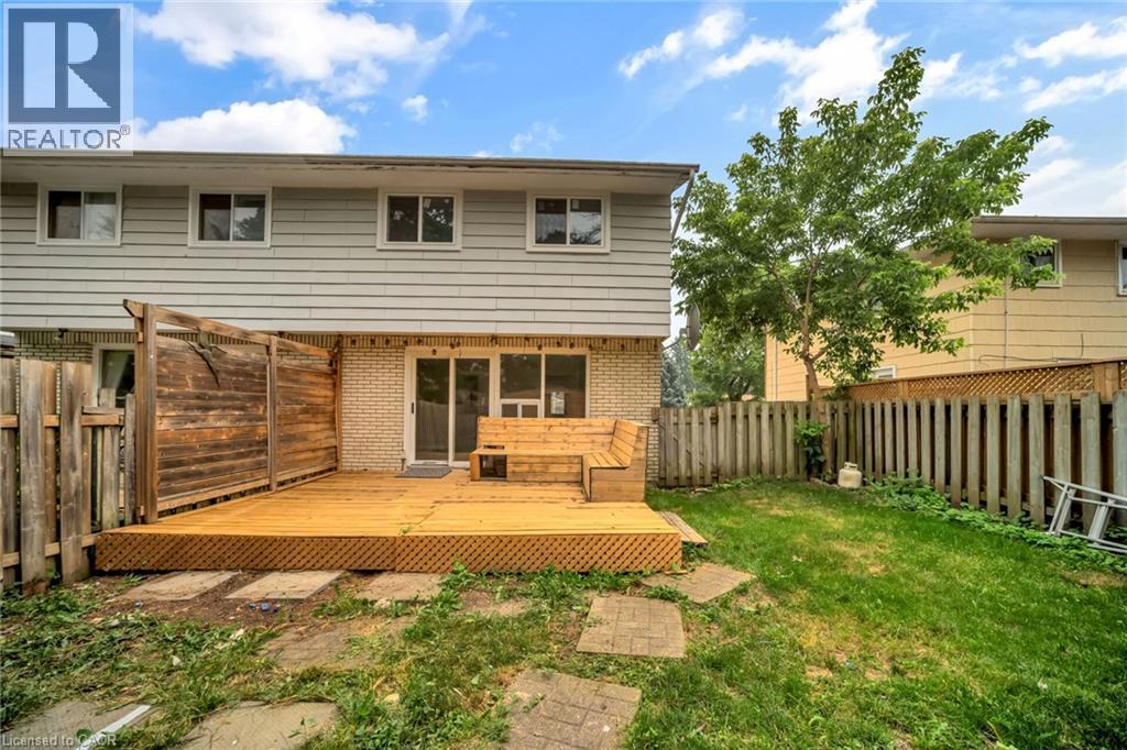 Expansive wood deck with an integrated bench seating area - 53 Burns Drive, Guelph, ON - Outdoor With Deck Patio Veranda