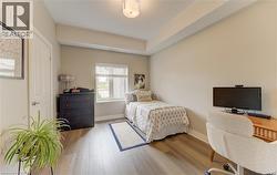 Room featuring wood-finish flooring, neutral wall tones, a window with blinds, and white trim -