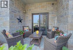 Stone-clad patio with a sliding glass door entry -