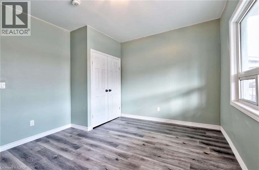 Interior room featuring wood-finish flooring and light-toned walls - 111 Gibson Avenue Unit# A, Hamilton, ON - Indoor Photo Showing Other Room